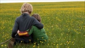 Children Sat Together | Field of Grass | Family Law Company