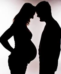 Silhouette of pregnant woman, and a man 